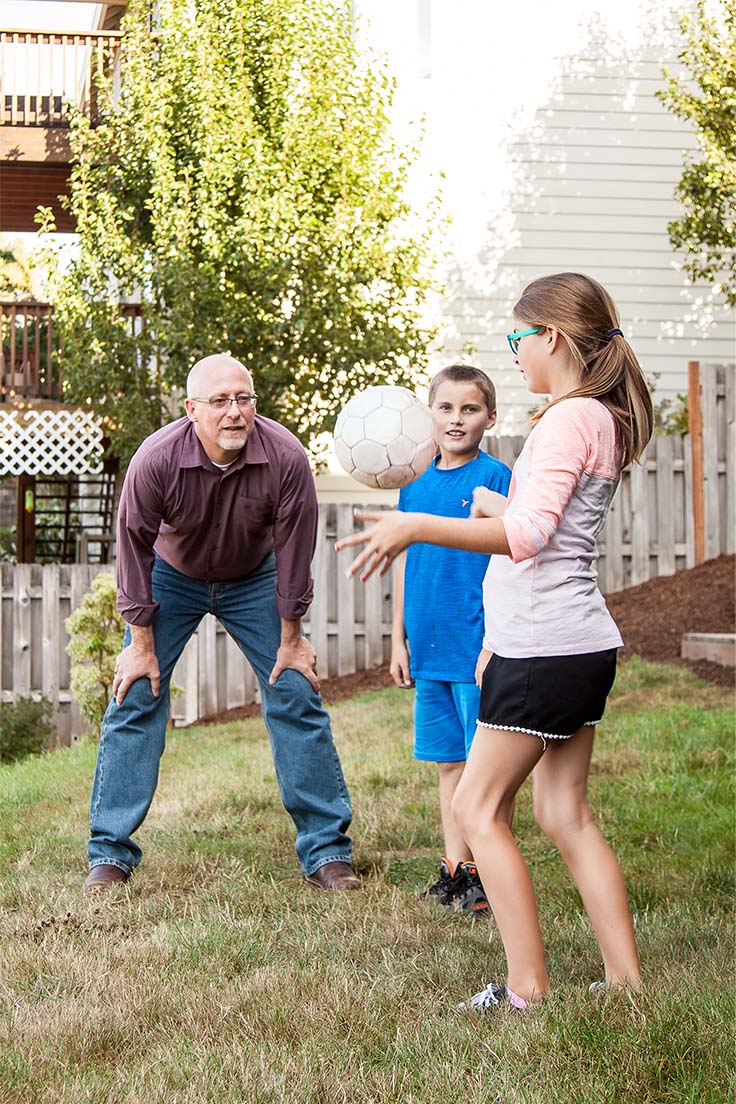 Ron Noble playing volleyball with grandkids